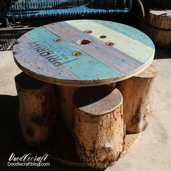 How to make a Blue Ombre Spool Patio Table Upcycle!This spool table has a fun nautical vibe and it's perfect for sitting on the patio for lunch! This blue finish is not quite ombre, but has variegated blue tones for the perfect Summer-ocean inspired furniture upcycle.