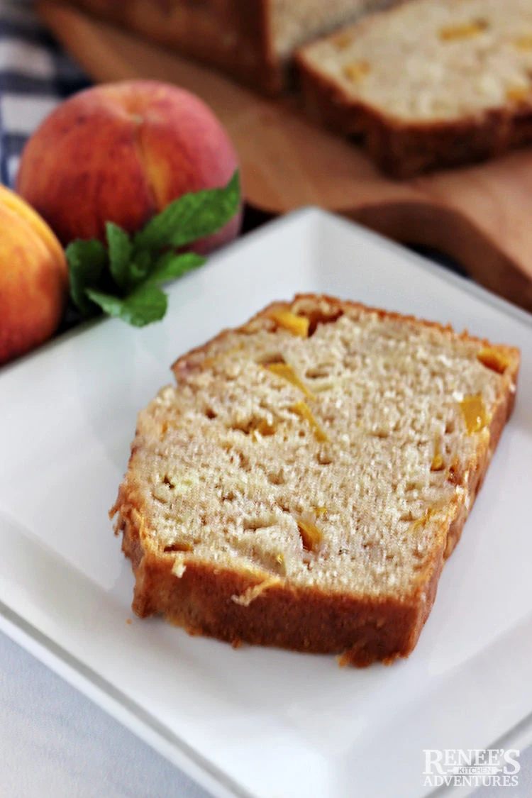 A slice of peach bread on a white plate