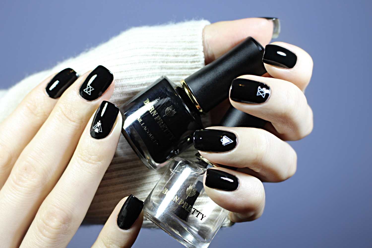 a close-up of a basic black nails looks with glossy finish on a short, natural nails
