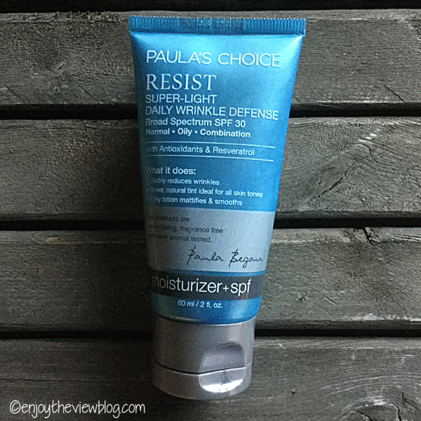 Tube of Paula's Choice RESIST Super-Light Daily Wrinkle Defense lying on a wooden table