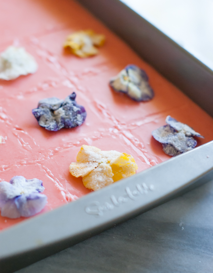 sugar cookie bars with strawberry glaze and edible flowers