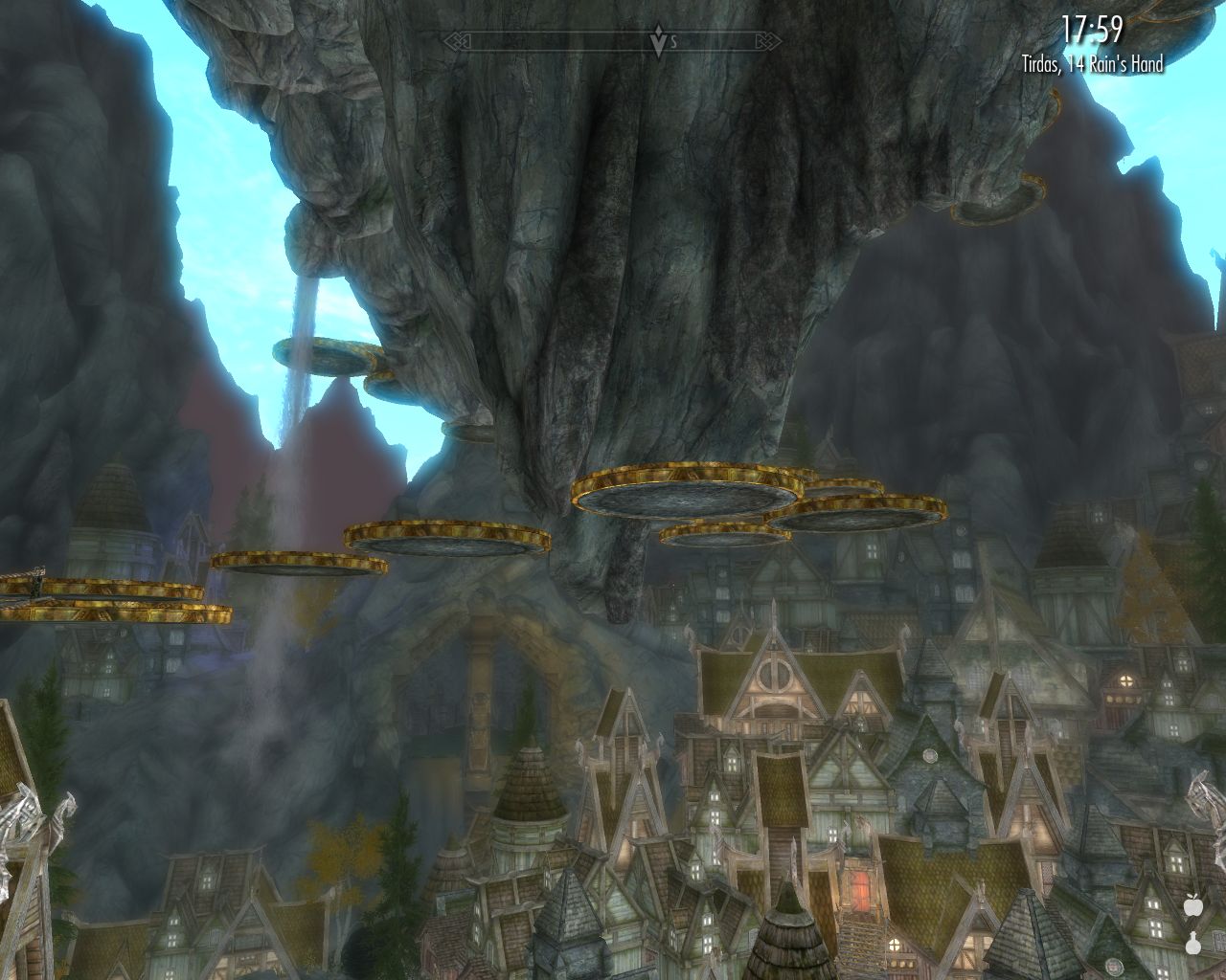 half a dozen plate.shaped things float high above the city, very high rocky mountains in the background