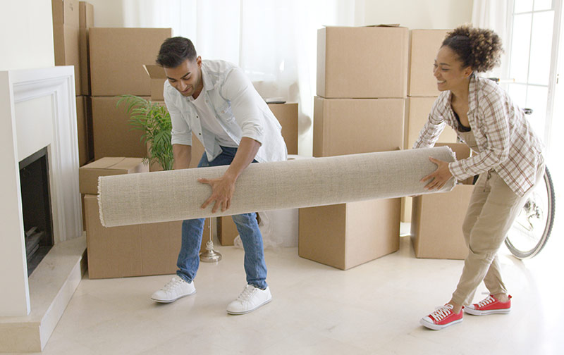 couple placing area rug