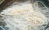Boiling noodles for chicken hakka noodles in a pan