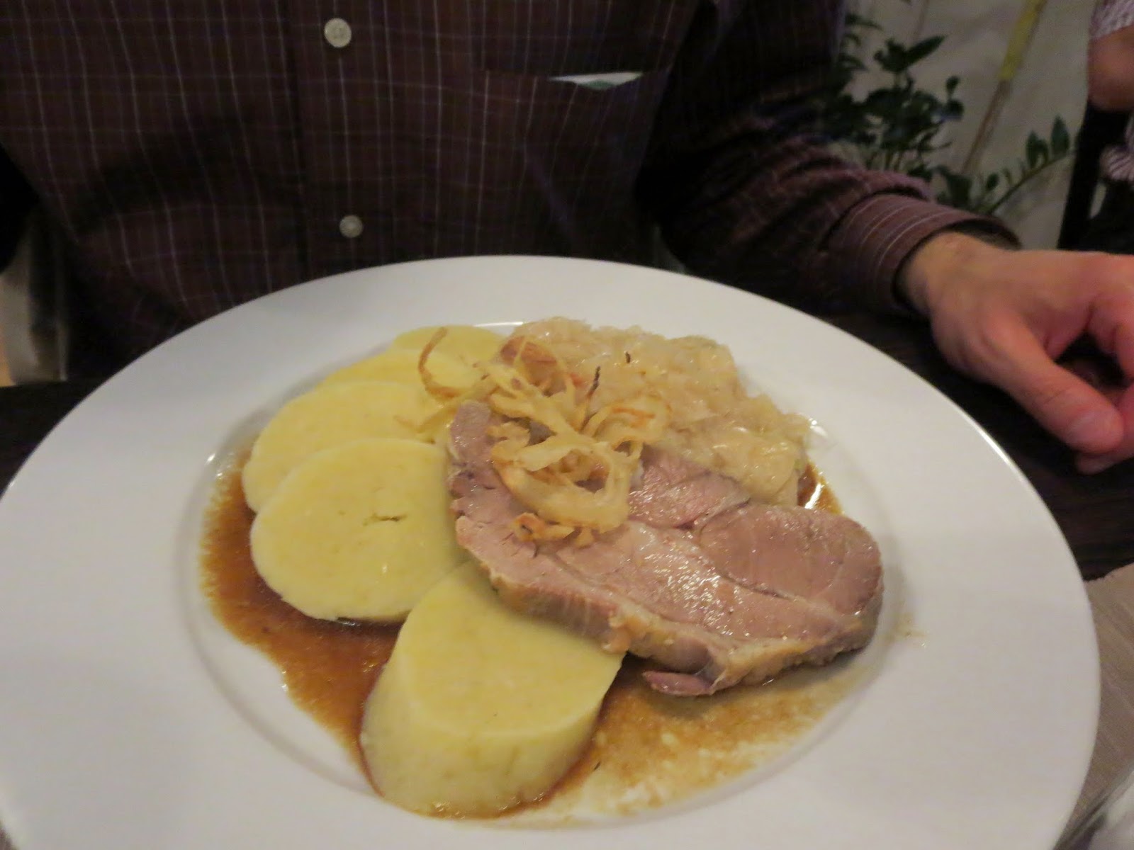 Traditional Czech roast pork with cabbage and potato dumplings at U Kroka Restaurant in Prague