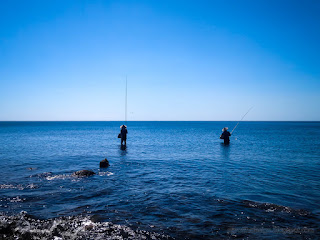 Beautiful Tropical Fishing Beach Scenery With Two Fishermen Fishing On A Sunny Day At The Village Umeanyar North Bali Indonesia