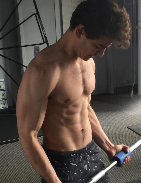 hot-fit-gym-bro-shirtless-young-curly-dude-lifting-weights