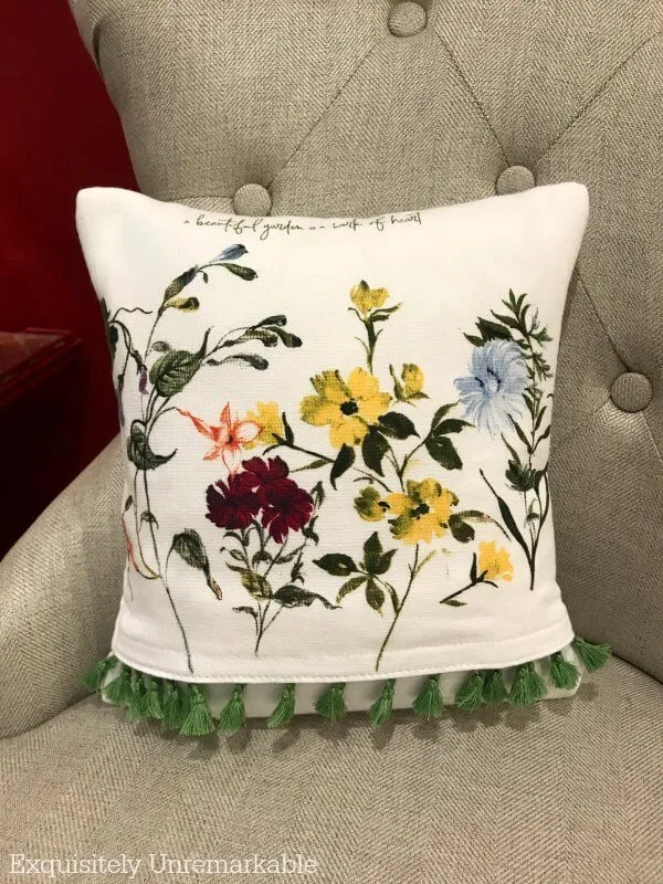 Floral fringed DIY dish towel pillow on a chair