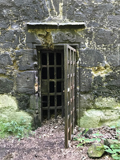 Entrance to Doocot, with remains of carved serpent on lintel above the door, which is a symbol for the Biblical saying - Be ye wise as serpents and harmless as doves. Photo by Kevin Nosferatu for the Skulferatu Project.