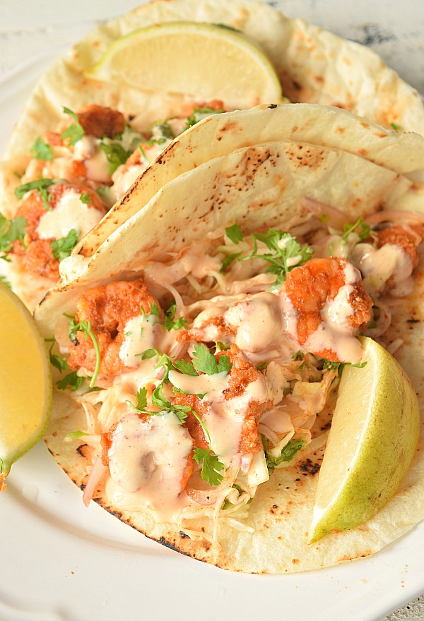 a close up of spicy shrimp tacos