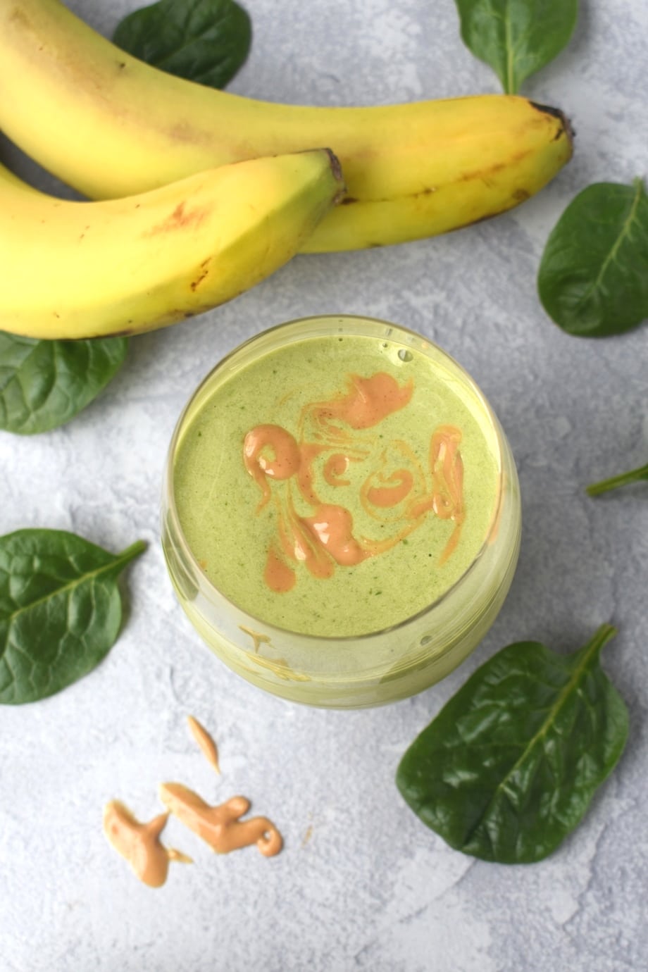 Peanut Butter Banana Green Smoothie with drizzled peanut butter