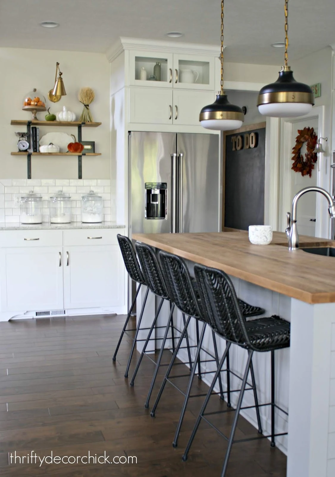Black stools light gray island white kitchen