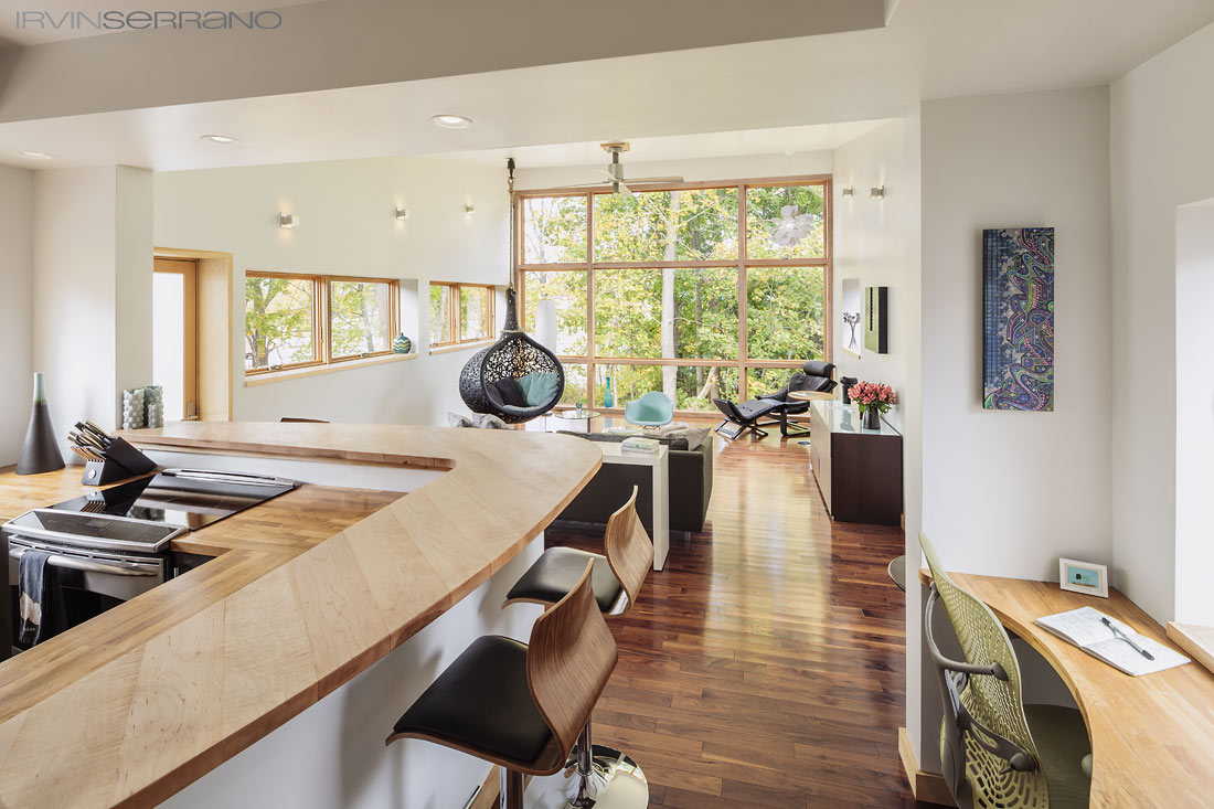 An open concept, hardwood floors and countertops make up the space in the kitchen and living room of architect Darren Commerford's dream home in South Portland, Maine.