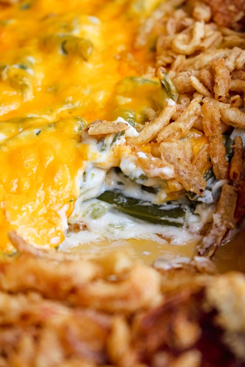 Sour Cream Green Bean Casserole is a no mushroom, no canned soup version of the classic side dish that is made with fresh green beans, creamy sour cream, sharp cheddar cheese, and french fried onions.  This recipe feeds a crowd!  #greenbeans #sidedish #greenbeancasserole