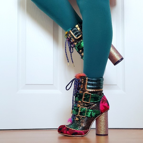 legs in green tights with green and pink metallic, snake and camo ankle boots