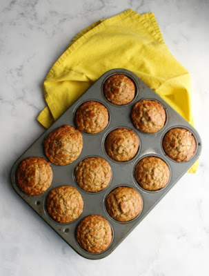 Whether you are looking for a grab and go breakfast or something for a leisurely weekend brunch, these banana oat muffins are perfect! pan of banana oatmeal muffins straight from the oven