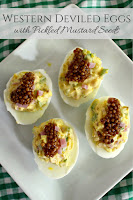 Western style deviled eggs - diced ham, onion and green pepper mixed with yolks and topped with sweet pickled mustard seeds. Deviled eggs make the perfect one-bite party appetizer!