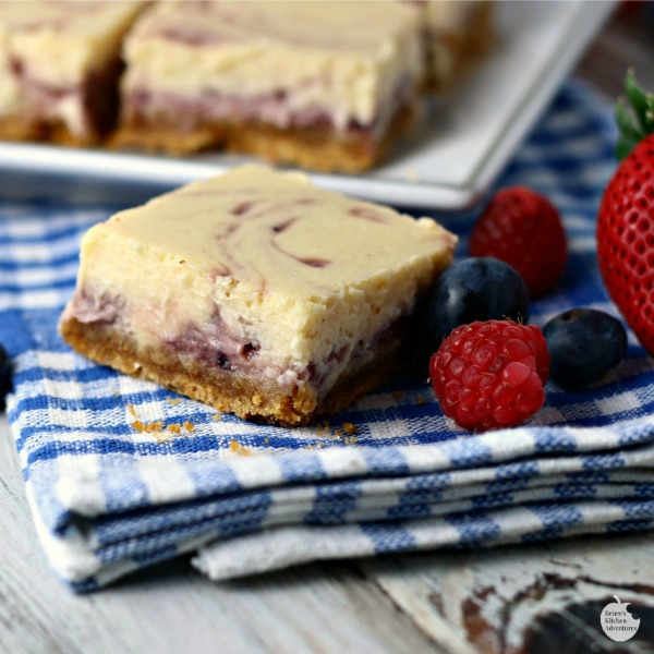 Triple Berry Swirl Cheesecake Bars | by Renee's Kitchen Adventures - easy recipe for perfect cheesecake swirled with sweet summer berries