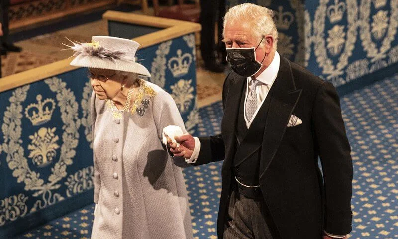 Queen Elizabeth wore a grey jacquard coat with lemon flowers, and a grey and yellow silk dress, and hat by Angela Kelly