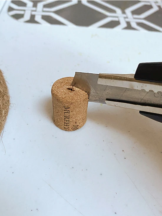 cutting a cork with a craft knife