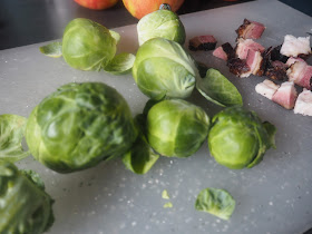 brussel sprouts and bacon on a chipping board
