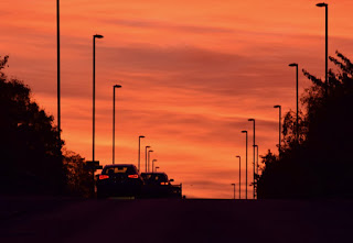 A stunning sunrise over Harbottle Park with silhouettes of early morning cars on Walker Road