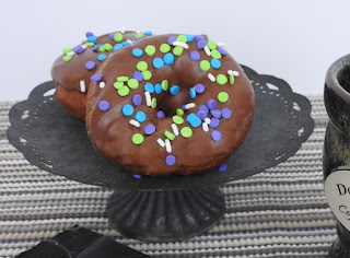 Chocolate frosted doughnuts with sprinkles