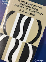 A Treatise on the Mathematical Theory of Elasticity, by A. E. H. Love, superimposed on Intermediate Physics for Medicine and BIology.