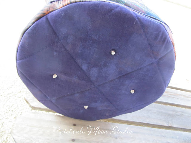Patchouli Moon Studio~ Round Tote Bag with Drawstring Top, Handles & Pockets View of the quilted bottom of the bag with added purse feet