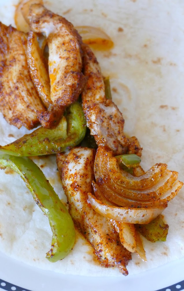 Dinner is on the table in 30 minutes with this easy Mexican recipe! All the flavors of a traditional fajita, baked in the oven, served on a flour tortilla with your favorite toppings! Great with chicken, steak or shrimp!