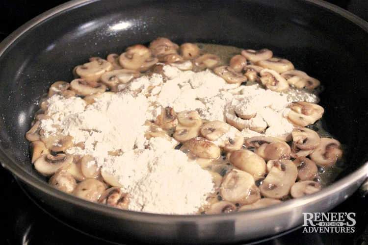 Flour added to skillet with sauteed mushrooms and shallots