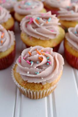 If you are a cookie dough lover, this is for you! It is basically safe to eat sugar cookie dough in frosting form and it's as good as it sounds! cupcakes decorated with sugar cookie dough frosting and cute sprinkles