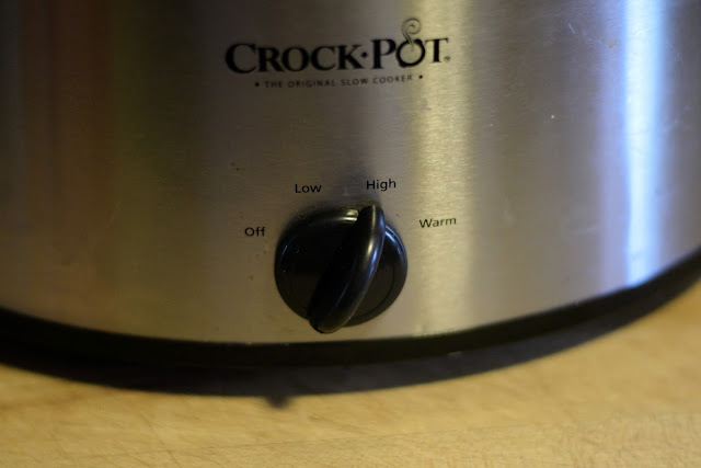 The dial on the crock pot set to HIGH.