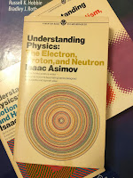 Understanding Physics: The Electron, Proton, and Neutron, by Isaac Asimov, suuperimposed on Intermediate Physics for Medicine and Biology.
