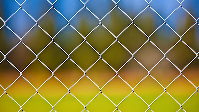 Desktop wallpaper with metal fence and iPhone