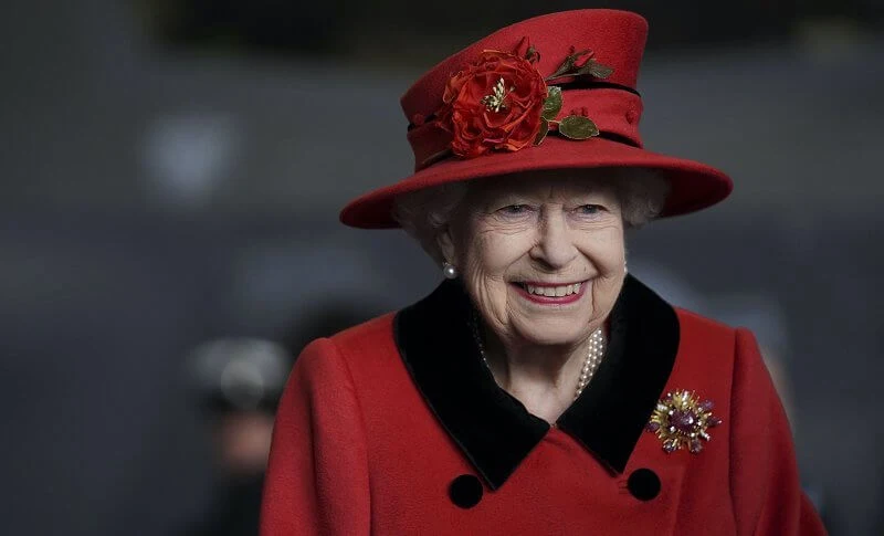 Queen Elizabeth wore a red coat, gold diamond brooch. HMS Queen Elizabeth and sister aircraft carrier HMS Prince of Wales