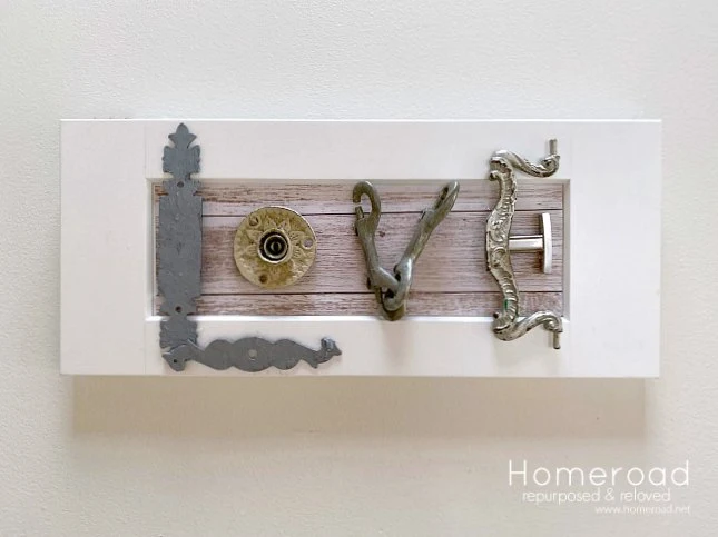 Love sign on a cabinet door with hardware