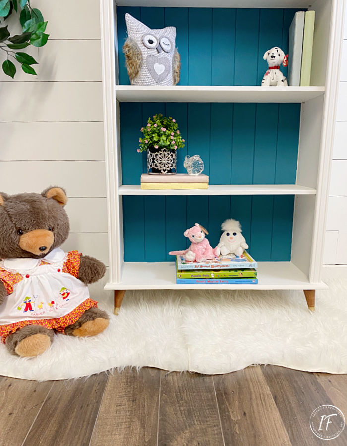 A small bookcase makeover for a baby nursery with mid-century modern style by replacing bun feet with vintage tapered wooden feet for a new look.