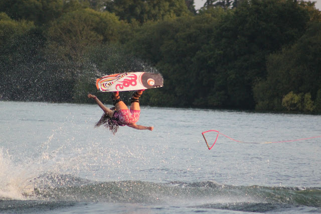 Women performs a wakeboarding move in the air