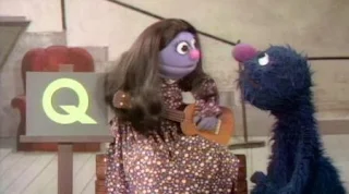 a little girl sings The Question Song with Grover about the letter Q. Sesame Street Alphabet Songs