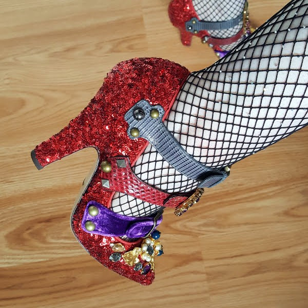 close up wearing red sequins shoes with multiple straps and buckles and embellishment