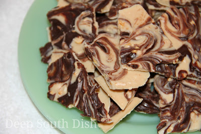 One of the easiest candies to make, this Tiger Butter Bark is made using almond bark candy coating mixed with peanut butter, topped with chopped peanuts and melted semi-sweet chocolate chips.
