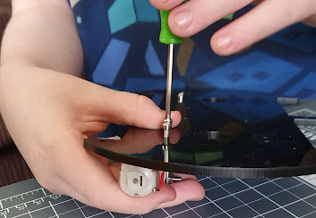 elegoo small boy hand with screwdriver building robot car kit