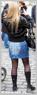 Girl in jean skirt and high heels on the street