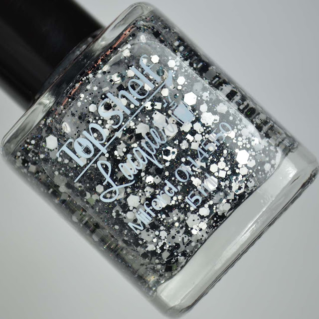 black and white glitter nail polish in a bottle
