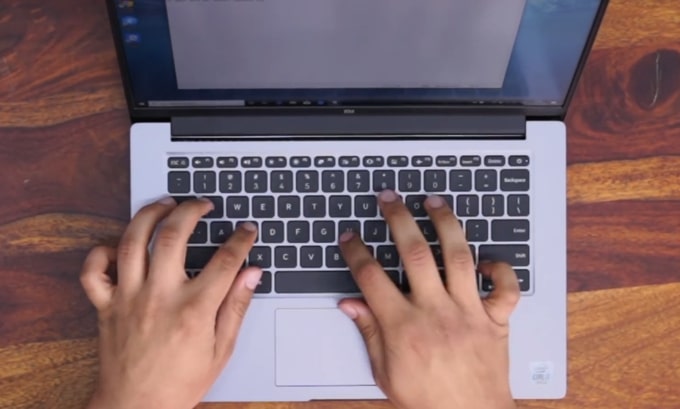 Typing on the keyboard of Mi Notebook 14 Horizon.