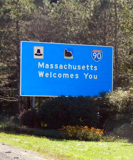 The state line sign in Massachusetts on Interstate 90