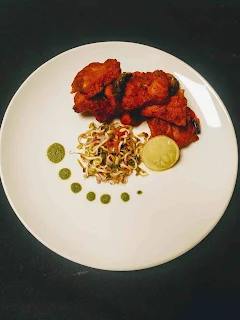 Serving fish Tikka with sprouts salad, green chutney and lemon wedges