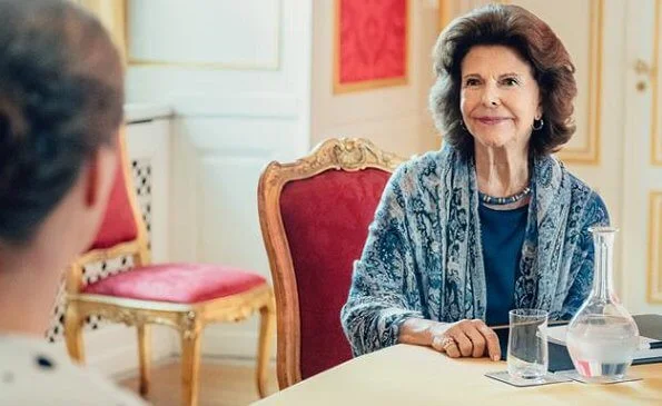 Queen Silvia wore a blue dress, and scarf, pearls necklace