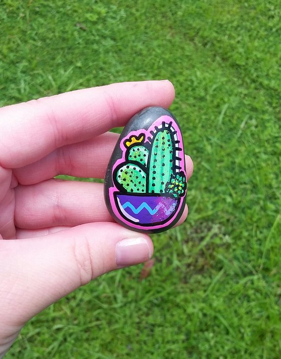 Hand painted cactus and succulent garden on a painted rock